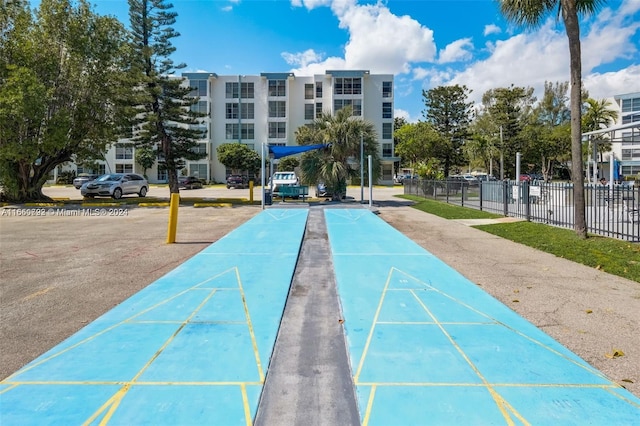 surrounding community with shuffleboard and fence