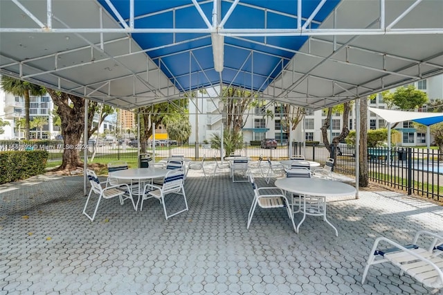 view of patio with fence and outdoor dining space