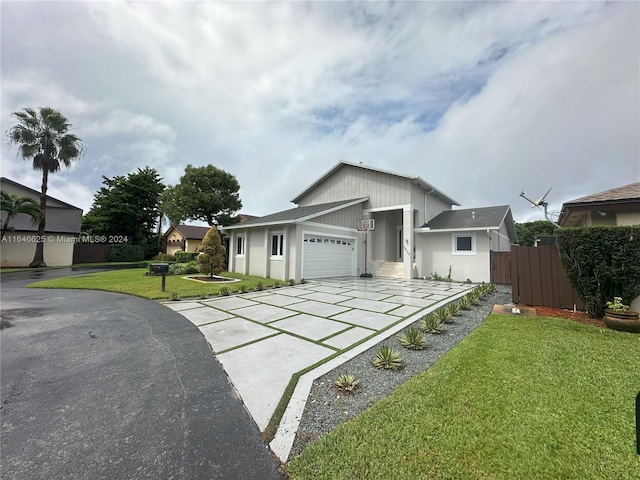 view of front facade featuring a garage and a front lawn