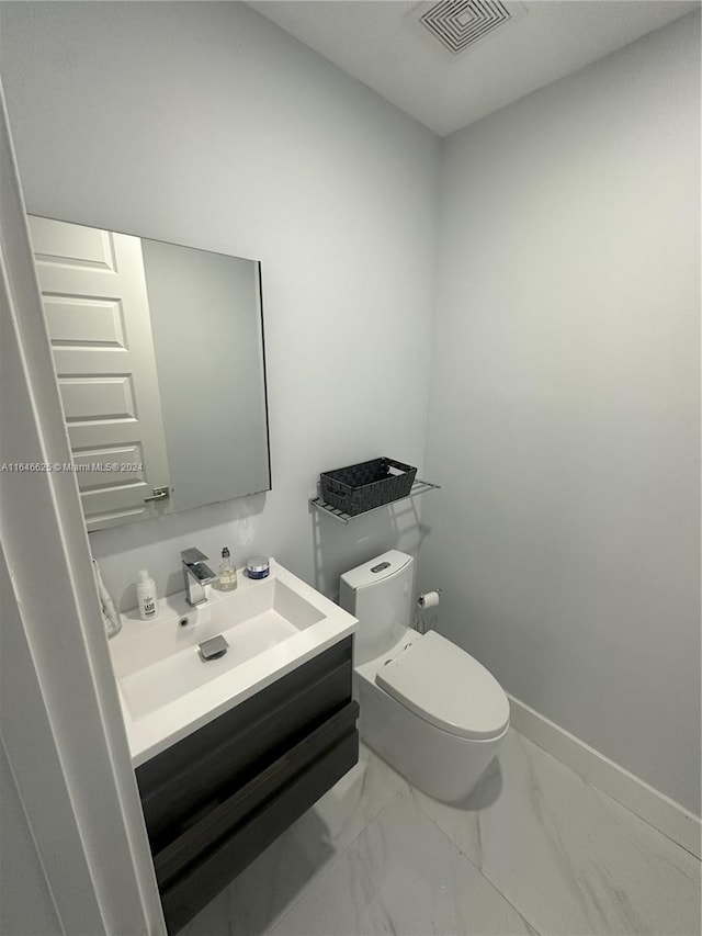 bathroom featuring vanity and toilet