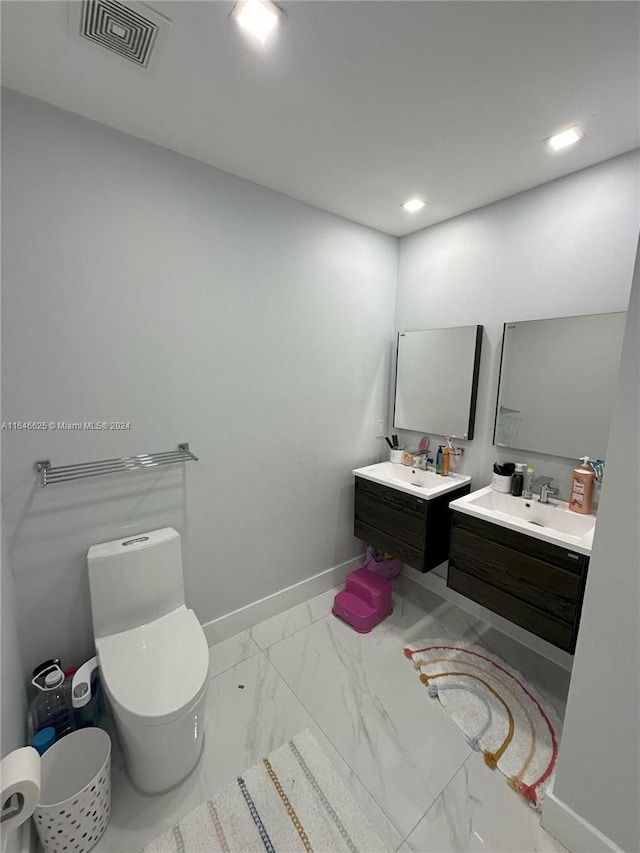 bathroom featuring vanity and toilet