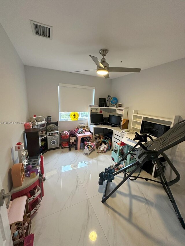 interior space with ceiling fan