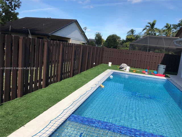 view of swimming pool with glass enclosure