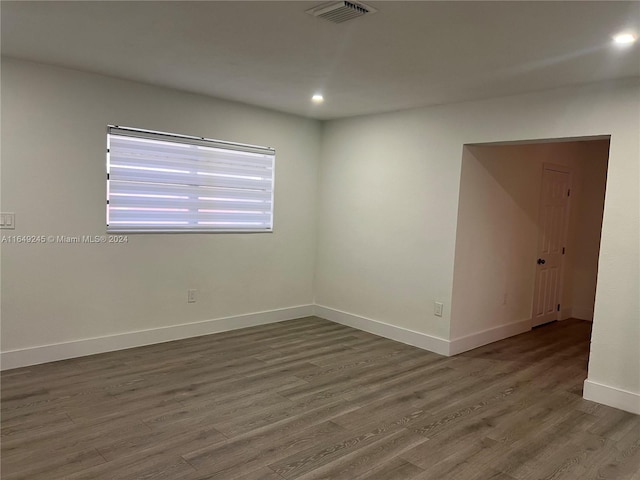 unfurnished room with hardwood / wood-style flooring