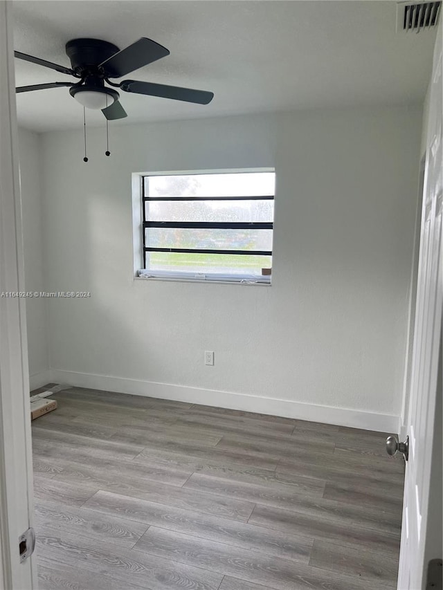 spare room featuring ceiling fan and light wood-type flooring