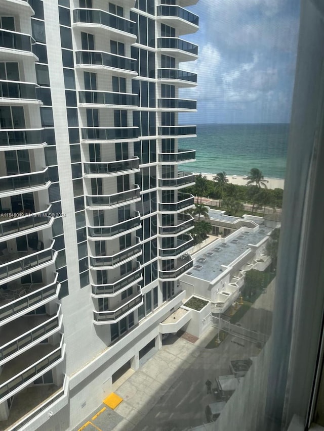 exterior space with a water view and a view of the beach