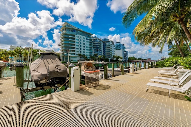 view of community with a water view and a boat dock