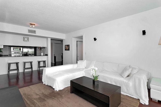 living room with a textured ceiling