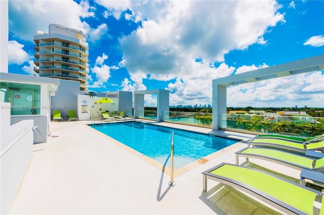 view of swimming pool featuring a patio area and a water view