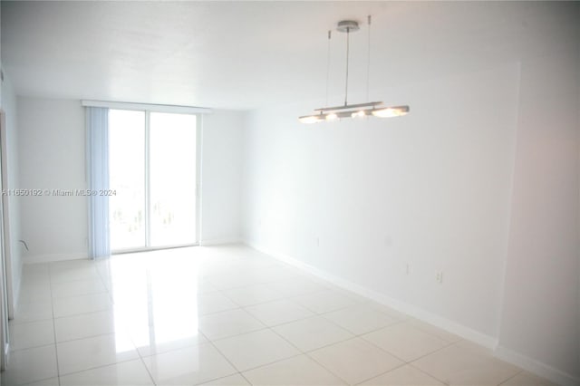 tiled spare room featuring a wealth of natural light