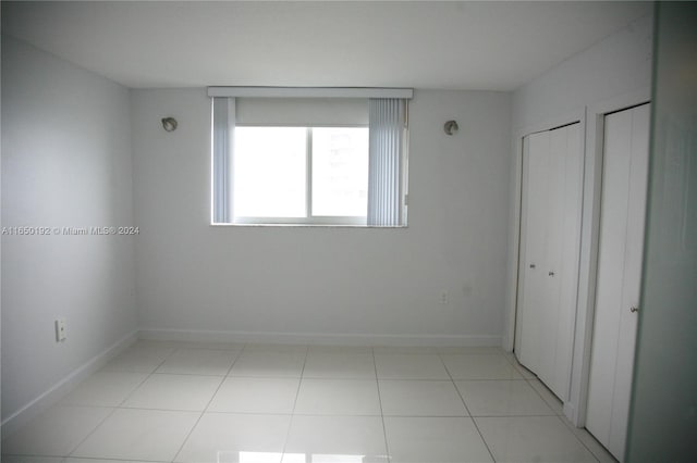 unfurnished bedroom featuring light tile patterned floors