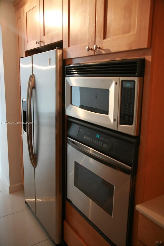 kitchen with appliances with stainless steel finishes and light tile patterned flooring