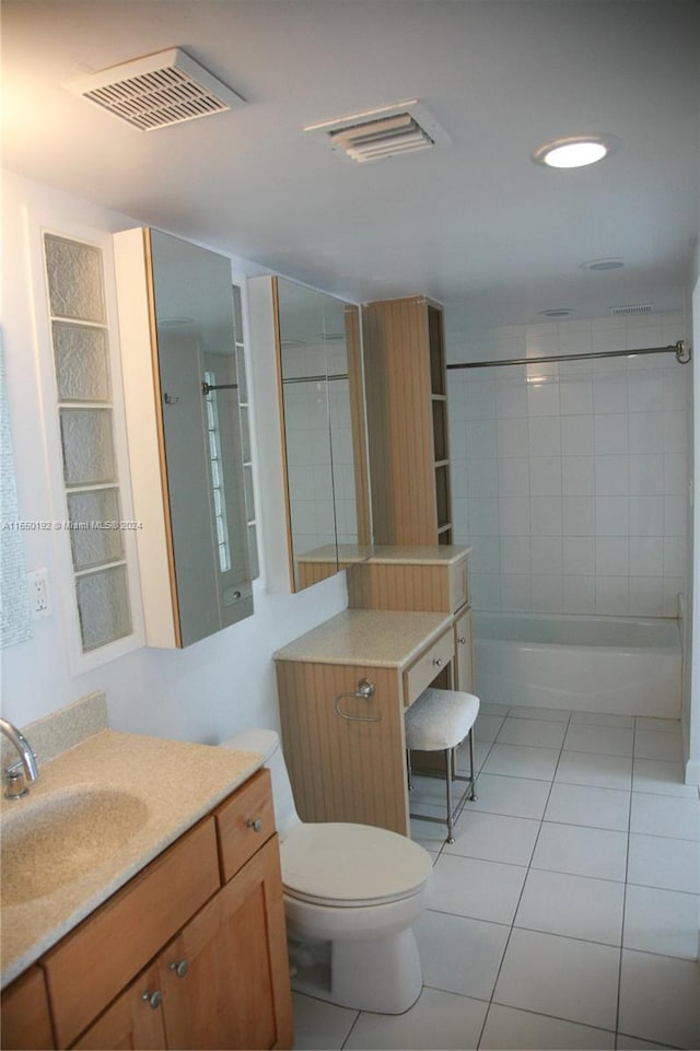 full bathroom featuring tiled shower / bath combo, vanity, toilet, and tile patterned floors