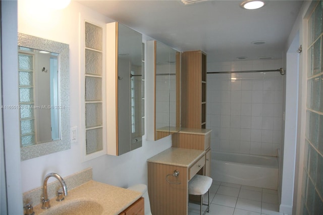 full bathroom with toilet, tile patterned flooring, tiled shower / bath combo, and vanity