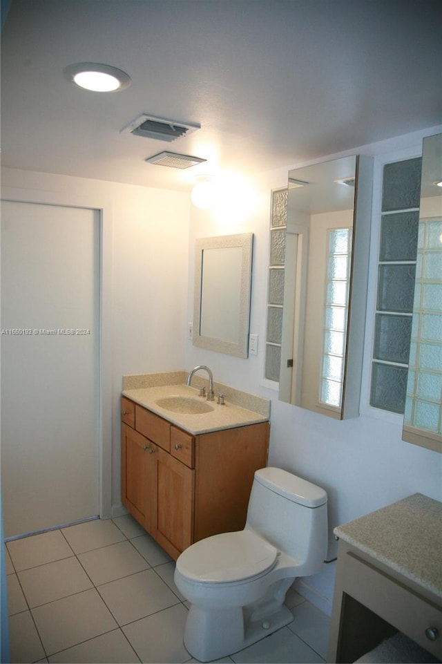 bathroom featuring vanity, toilet, and tile patterned floors