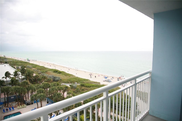 balcony with a water view and a beach view