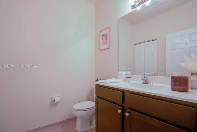 bathroom with vanity, toilet, and tile patterned floors