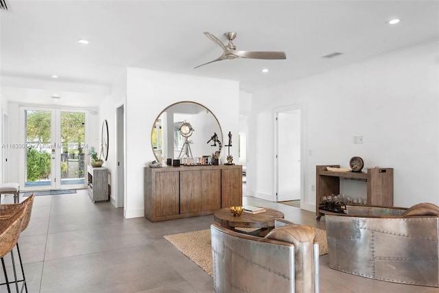 living room with concrete floors, ceiling fan, and french doors