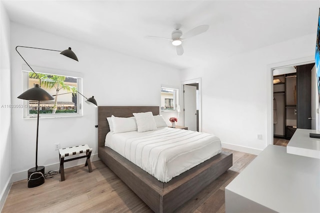 bedroom with light wood-type flooring and ceiling fan