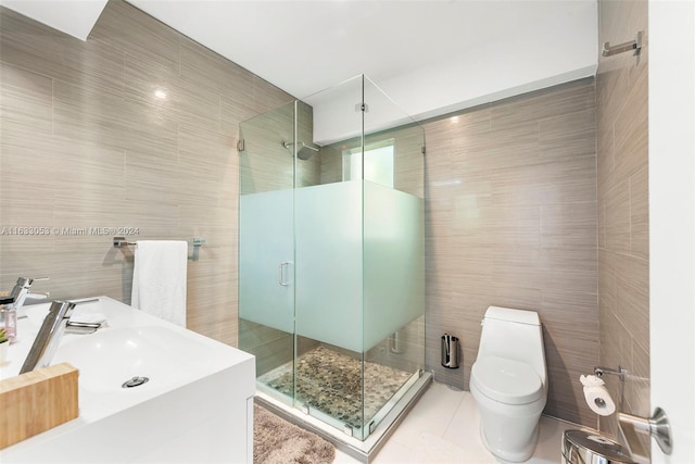 bathroom with tile walls, walk in shower, toilet, and tile patterned floors