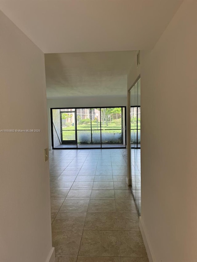 corridor featuring light tile patterned floors