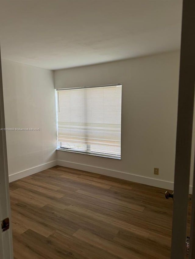 spare room featuring dark hardwood / wood-style flooring