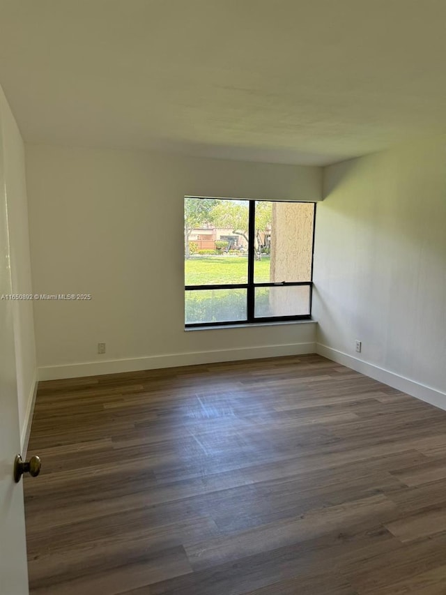 spare room featuring dark hardwood / wood-style flooring