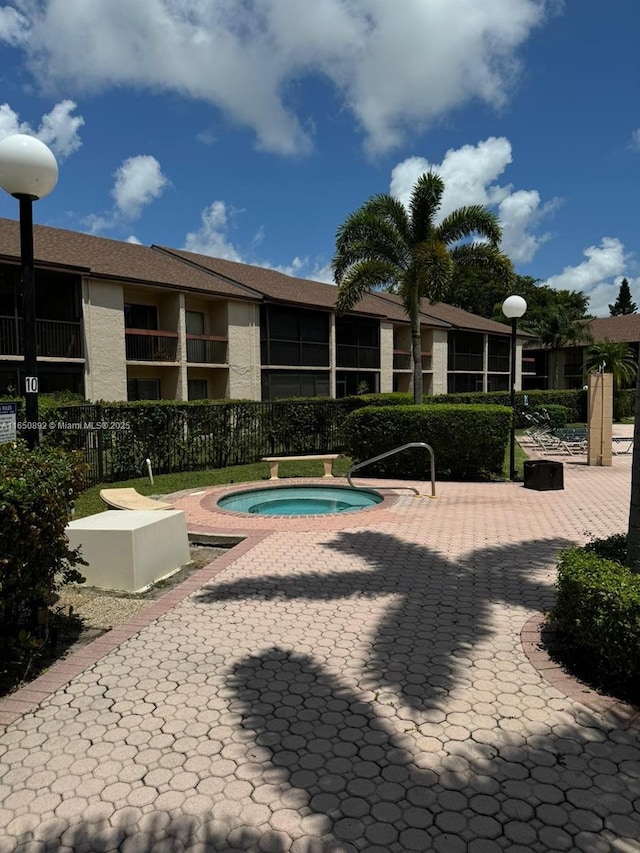 view of swimming pool featuring a hot tub