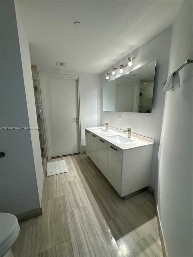 bathroom featuring vanity, hardwood / wood-style flooring, toilet, and an enclosed shower