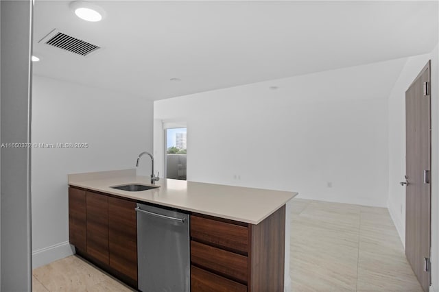 kitchen with a peninsula, a sink, visible vents, light countertops, and modern cabinets