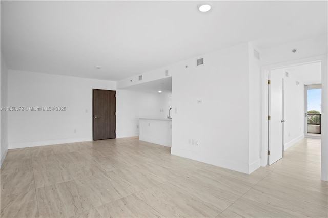 empty room with visible vents and baseboards