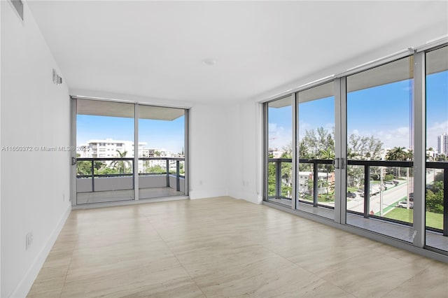 spare room with a wall of windows