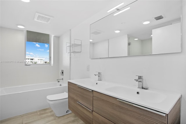 bathroom featuring toilet, a sink, and visible vents