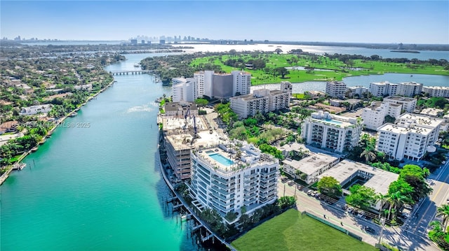 drone / aerial view featuring a view of city and a water view