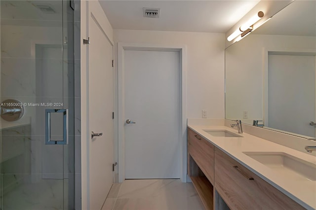 bathroom featuring vanity and a shower with shower door