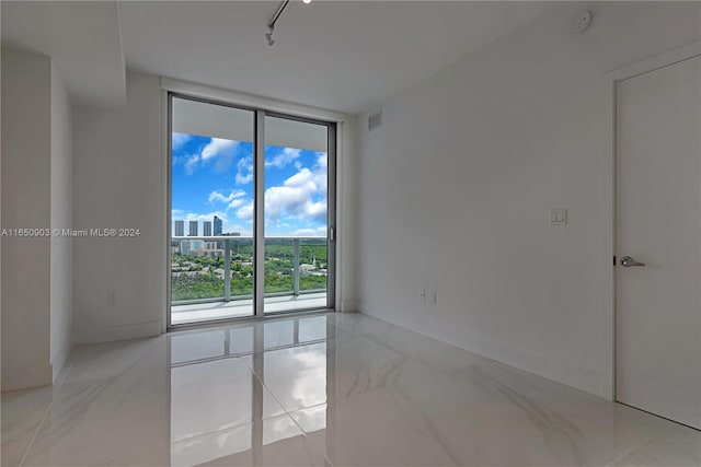 spare room featuring floor to ceiling windows