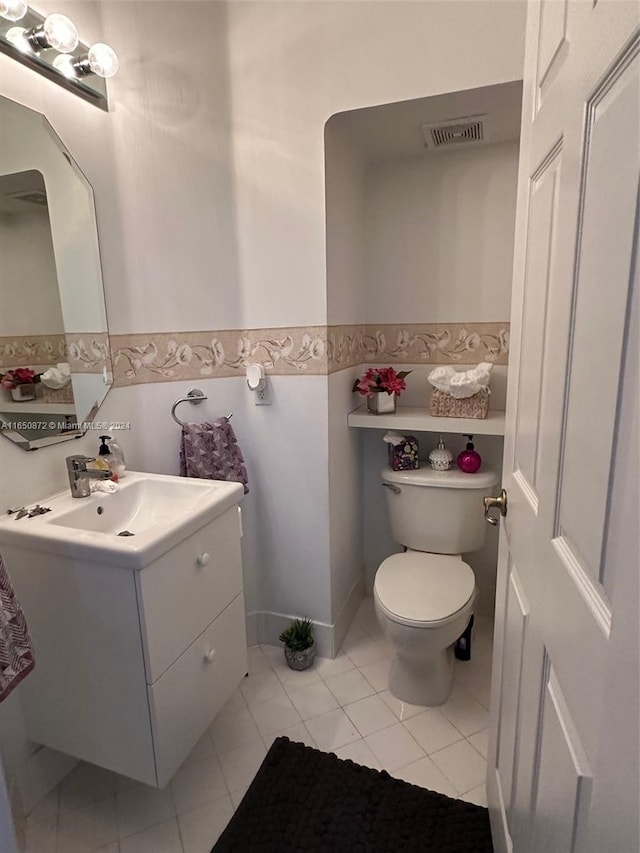 bathroom featuring vanity, toilet, and tile patterned flooring