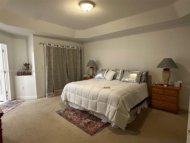 bedroom with a textured ceiling and carpet