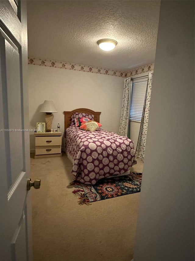 carpeted bedroom with a textured ceiling