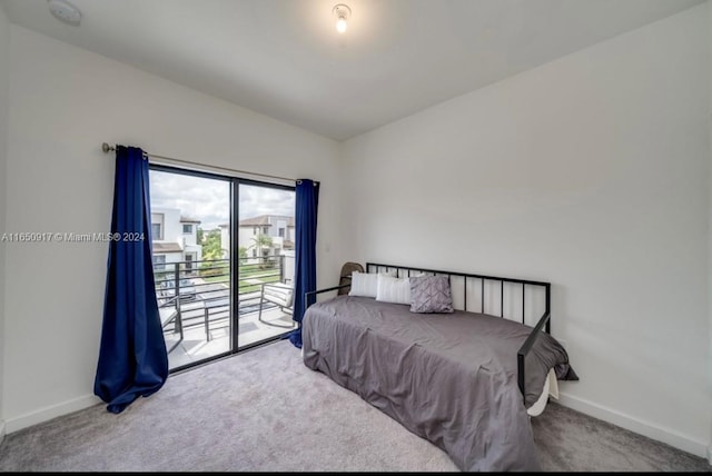 bedroom with lofted ceiling, carpet, and access to outside