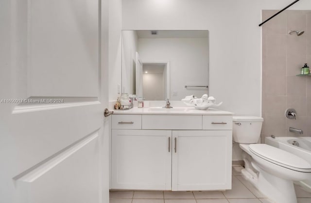 full bathroom featuring tile patterned flooring, vanity, toilet, and tiled shower / bath