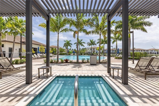 view of swimming pool with a patio and a pergola