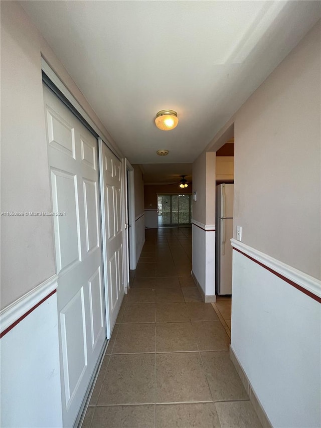 corridor with light tile patterned flooring