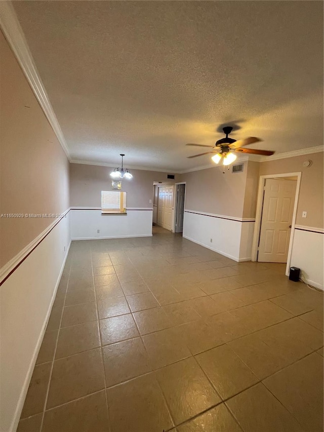 unfurnished living room featuring a textured ceiling, crown molding, ceiling fan with notable chandelier, and tile patterned flooring