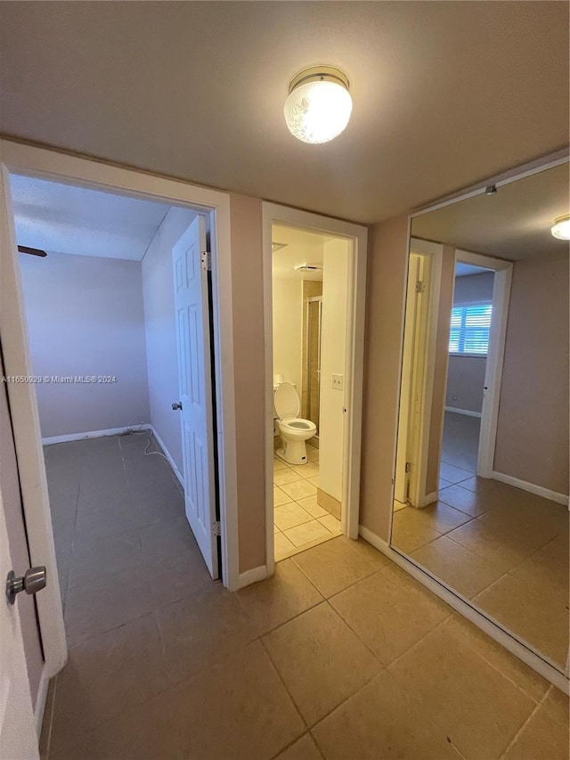 corridor featuring light tile patterned floors