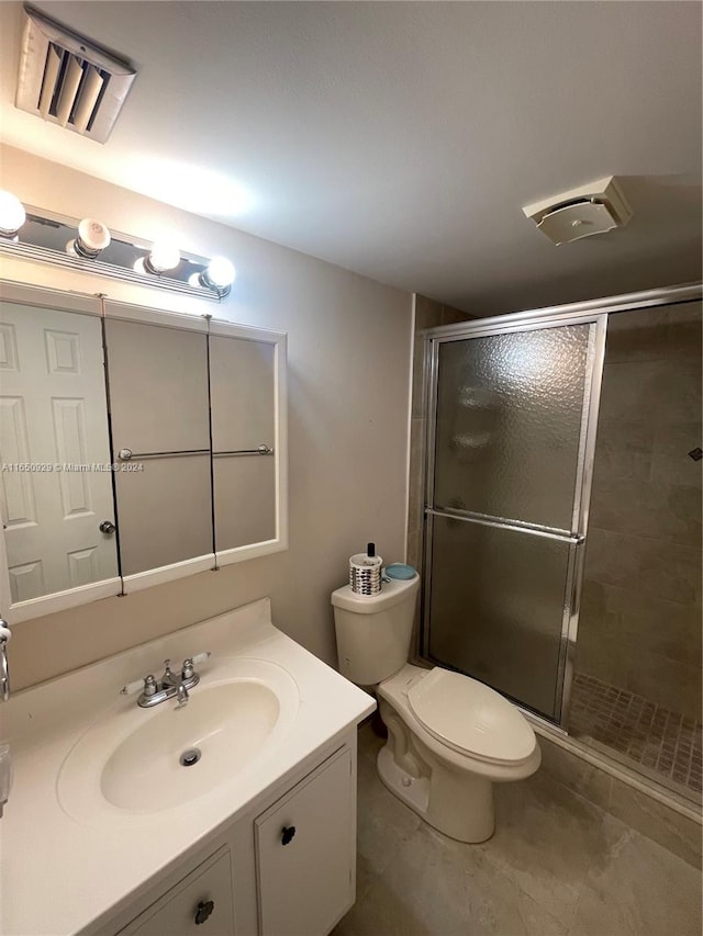 bathroom with vanity, toilet, and walk in shower