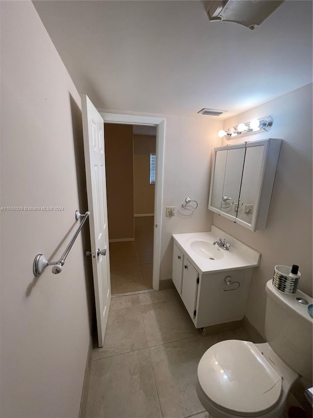 bathroom featuring vanity, toilet, and tile patterned floors