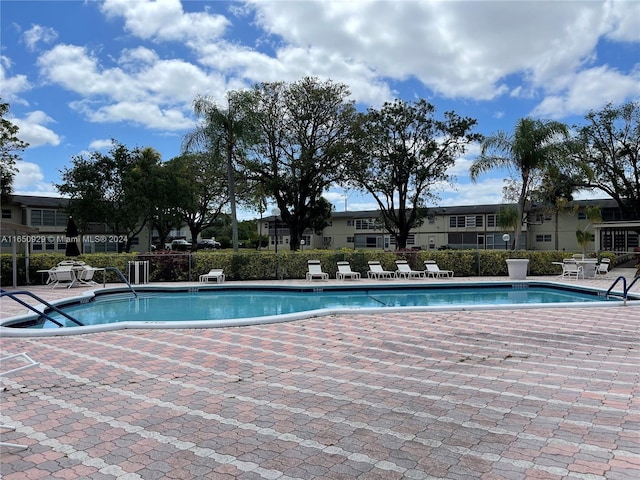 view of swimming pool with a patio area