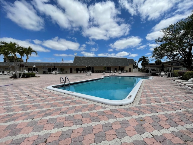 view of swimming pool featuring a patio area