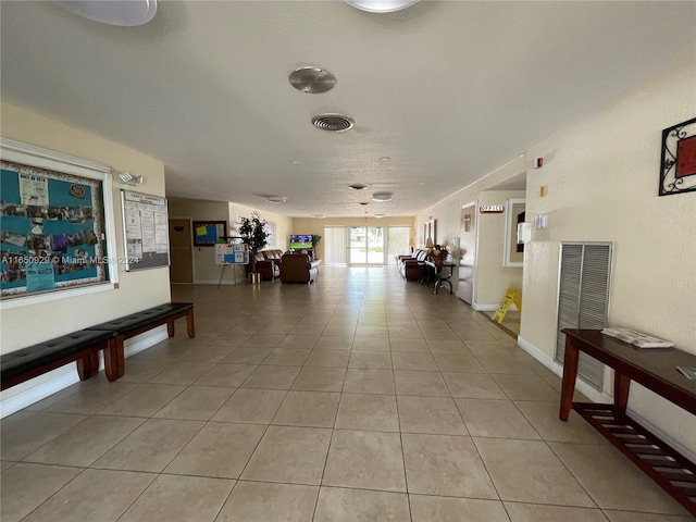 corridor featuring light tile patterned flooring